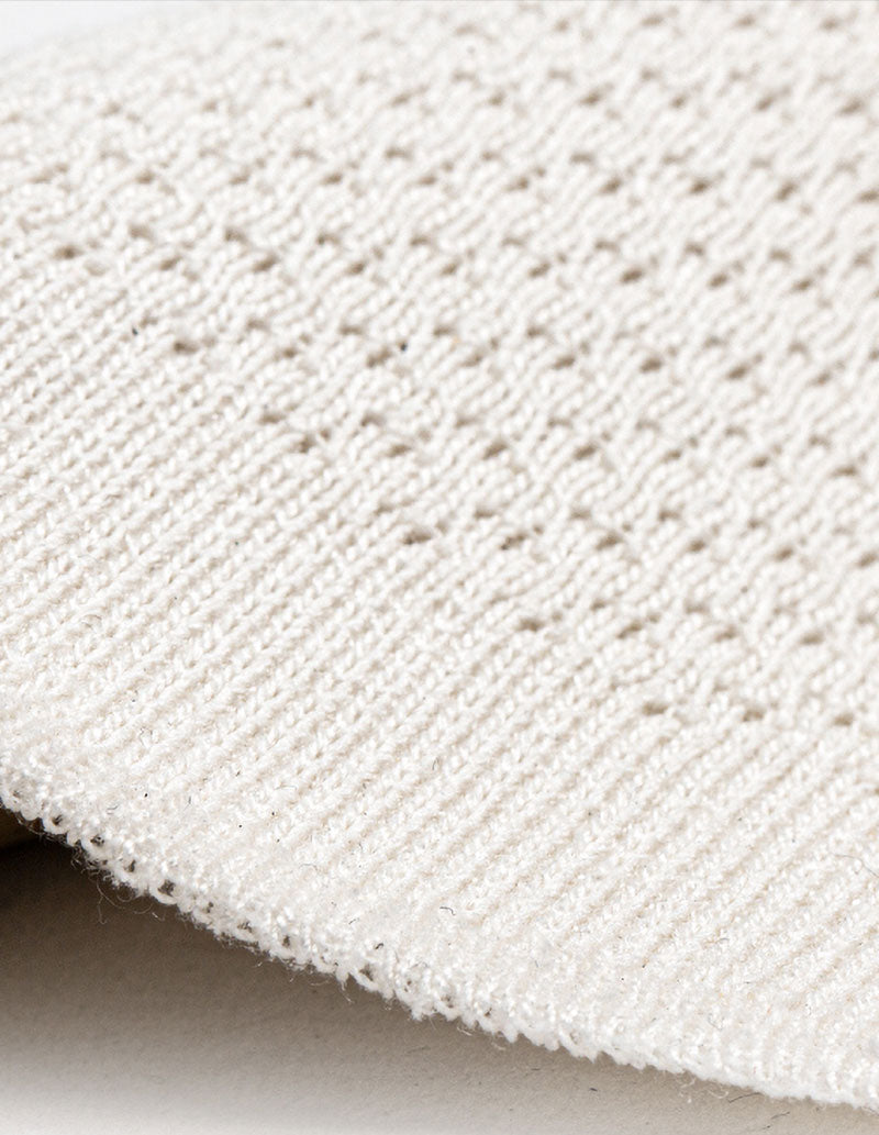 Close-up of a textured white fabric surface
