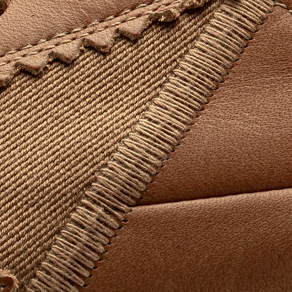 Close-up of brown leather with textured stitching