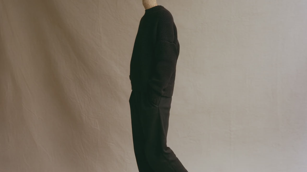 A man with a mushroom head walks through a photo studio